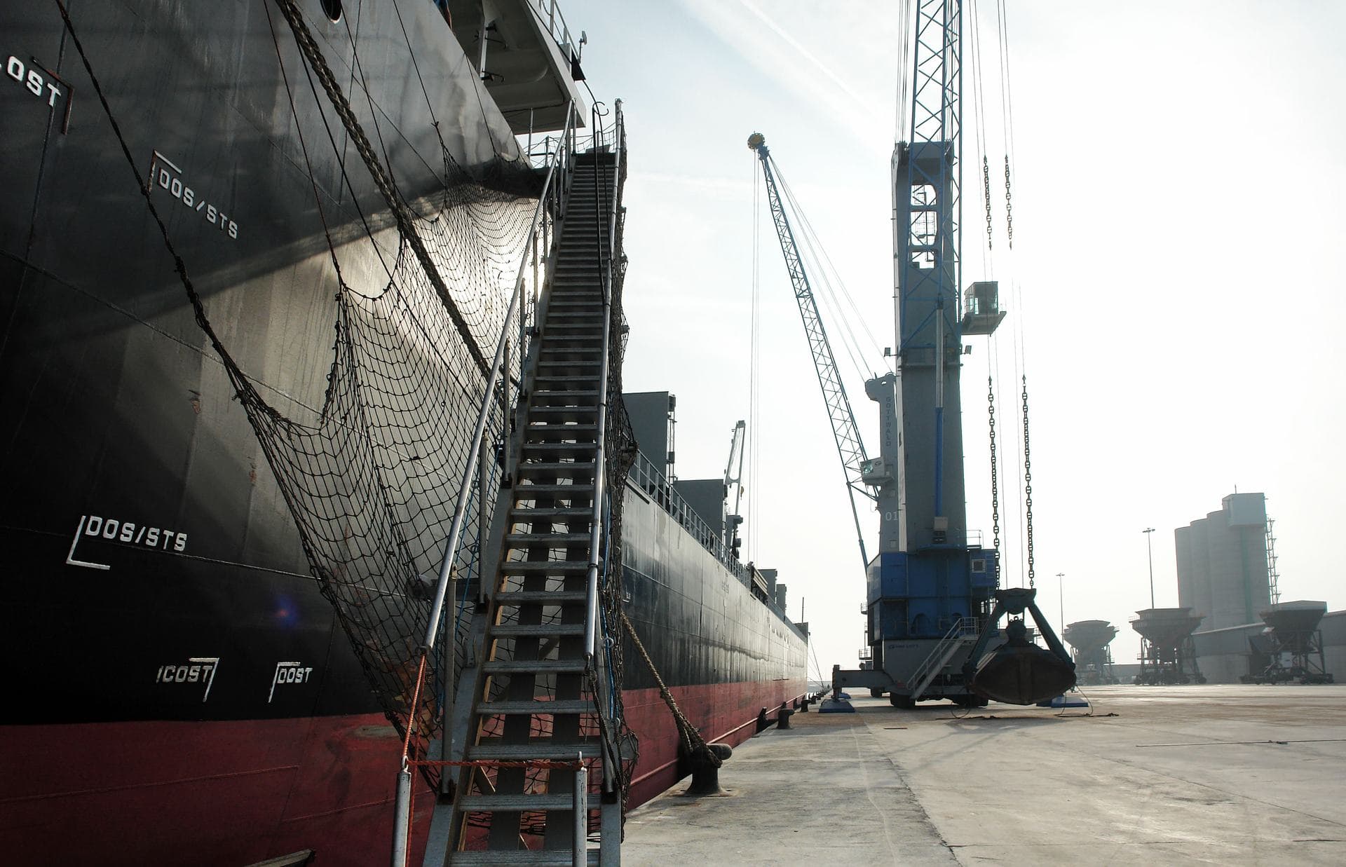A vessel alongside the quay with cranes working the berth